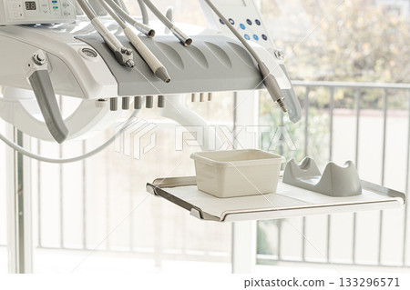 Dental equipment, doctor's unit,module, in a bright clinic, with modern technology, no people, natural light Dental equipment, doctor's unit,module, in a bright clinic, with modern technology, no people, natural light 133296571