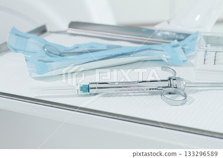 a carpal syringe, reusable, for use in dentistry, for the administration of anesthetic, lies on the table a carpal syringe, reusable, for use in dentistry, for the administration of anesthetic, lies on the table 133296589