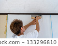 Remove excess wallpaper with a cutter 133296810