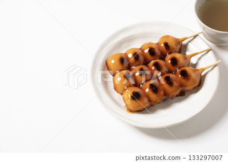 Mitarashi dumplings on a white plate Mitarashi dumplings on a white plate 133297007