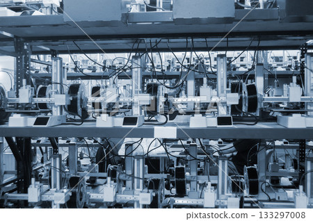 Many 3D printers printing an object. 3D printers simultaneously printing model from molten plastic. Many 3D printers creating shape from molten plastic flowing out of extruder. 3D printing technology 133297008