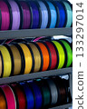 Spools with multi-colored plastic for 3D printing. Spools with pink, red, burgundy, purple, yellow, orange blue plastic wire for 3D printer. Components for 3D printing. Accessories for 3D printer 133297014
