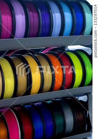 Spools with multi-colored plastic for 3D printing. Spools with pink, red, burgundy, purple, yellow, orange blue plastic wire for 3D printer. Components for 3D printing. Accessories for 3D printer Spools with multi-colored plastic for 3D printing. Spools with pink, red, burgundy, purple, yellow, orange blue plastic wire for 3D printer. Components for 3D printing. Accessories for 3D printer 133297014