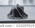 Prototype turbine compressor wheel printed on a 3D printer. Small model turbine rotor created on a 3D printer from molten plastic. 3D printing technology. New modern additive FDM printing technologies 133297019