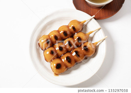 Mitarashi dumplings on a white plate Mitarashi dumplings on a white plate 133297038