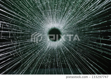 Intricate Patterns of Cracked Glass with Light Rays Radiating from a Central Point 133297747