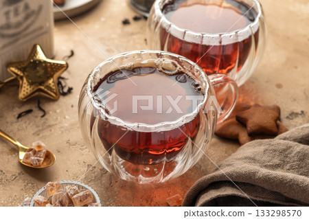 Black tea in two transparent glass cups on brown textured table background. Cozy breakfast teatime 133298570