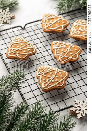 Freshly Baked gingerbread Christmas Cookies shaped like trees on Cooling Rack. Christmas baking Freshly Baked gingerbread Christmas Cookies shaped like trees on Cooling Rack. Christmas baking 133298631
