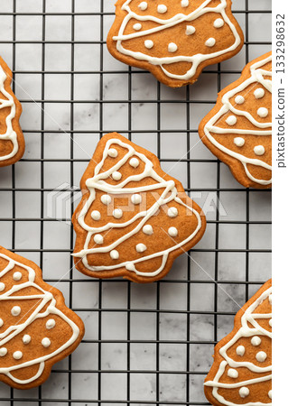Freshly Baked gingerbread Christmas Cookies shaped like trees on Cooling Rack close up. Christmas baking, top view Freshly Baked gingerbread Christmas Cookies shaped like trees on Cooling Rack close up. Christmas baking, top view 133298632