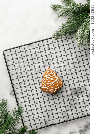 Freshly Baked gingerbread Christmas Cookie shaped like tree on Cooling Rack. Christmas baking, top view 133298635