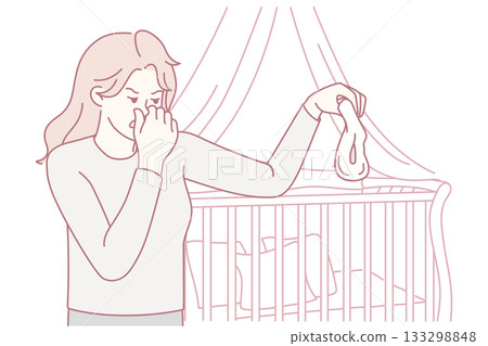 Unhappy mother holding stinky diaper Unhappy mother holding stinky diaper 133298848