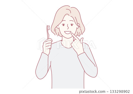 Smiling girl point at clean teeth 133298902