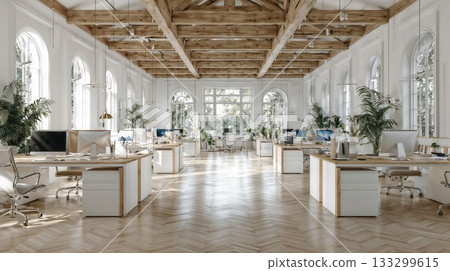 Bright modern office space with exposed wooden beams, white desks, computers and large arched windows creating airy collaborative workspace with natural light and plants 133299615