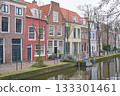Picturesque Netherlands. Bicycles parked alongside a channel on beautiful old buildings background. 133301461