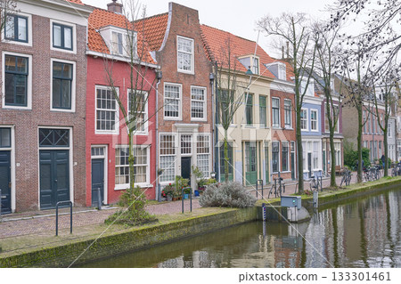 Picturesque Netherlands. Bicycles parked alongside a channel on beautiful old buildings background. 133301461
