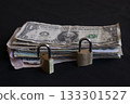 stack of international currency bills secured with padlocks on black 133301527