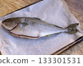 fresh yellowtail fish on parchment paper ready for cooking preparation 133301531