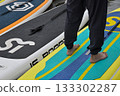 Human barefoot on a surfboard, close up of his legs 133302287