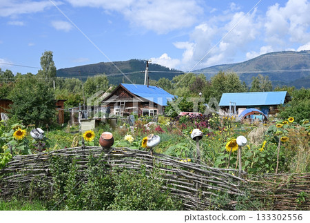 A traditional Russian hut with a wicker fence and pots A traditional Russian hut with a wicker fence and pots 133302556
