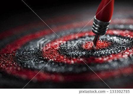 Red dart hitting center of target on black and red background Red dart hitting center of target on black and red background 133302785