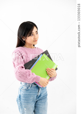 Young woman standing with notebook and files Young woman standing with notebook and files 133303018