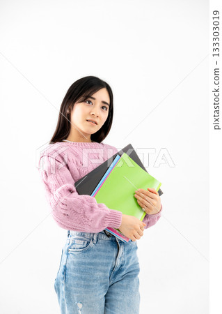 Young woman standing with notebook and files 133303019