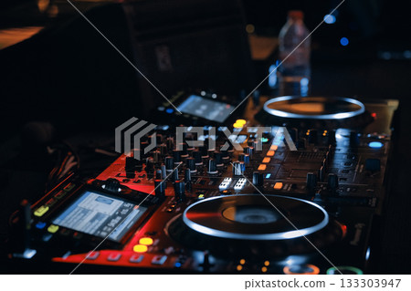 DJ Mixer Console in Nightclub DJ Mixer Console in Nightclub 133303947