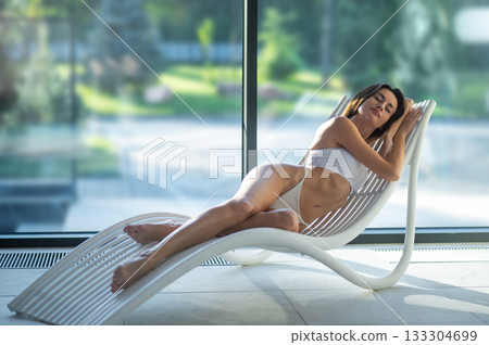 Beautiful and relaxed young woman looking peaceful and contented after spa procedures Beautiful and relaxed young woman looking peaceful and contented after spa procedures 133304699