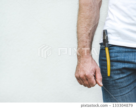 Attractive man, hand tools and work clothes 133304879