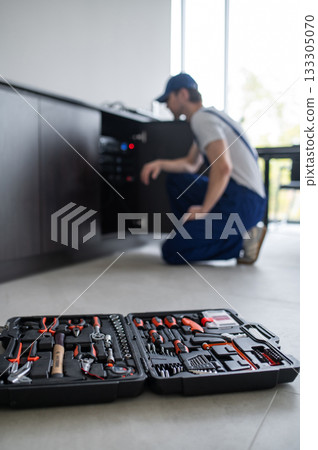 Technician calibrating professional speakers in office 133305070