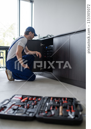 Audio engineer setting up speakers in office Audio engineer setting up speakers in office 133305072