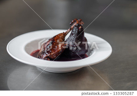 Braised meat served with sauce and artistic topinambur chips 133305287