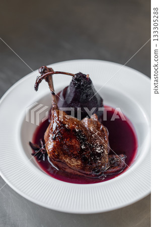 Braised lamb shank or duck leg with sauce and topinambur chips garnish Braised lamb shank or duck leg with sauce and topinambur chips garnish 133305288