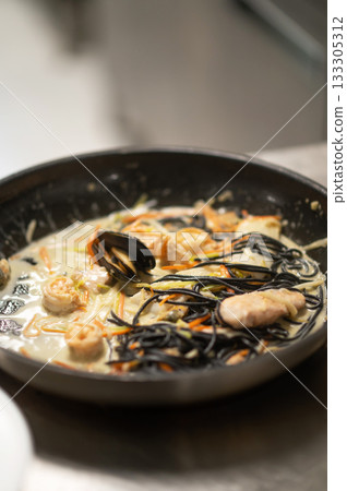 Delicious pasta with seafood mix served on elegant plate Delicious pasta with seafood mix served on elegant plate 133305312