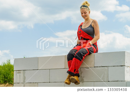 Female builder break on construction site Female builder break on construction site 133305438