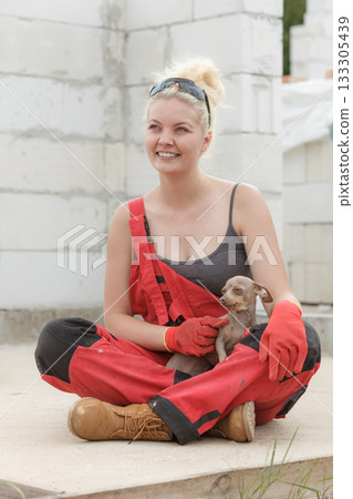 Woman with dog on construction site Woman with dog on construction site 133305439