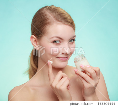 woman applying cream on her skin face. woman applying cream on her skin face. 133305454