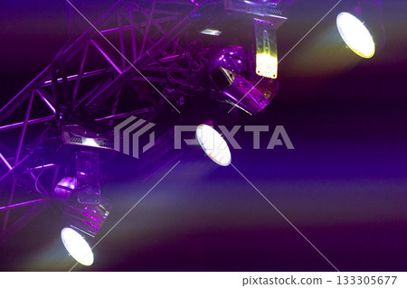 Multicolored beams of stage lighting illuminate the stage of the hall before the performance Multicolored beams of stage lighting illuminate the stage of the hall before the performance 133305677
