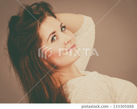 Happy positive woman with long brown hair Happy positive woman with long brown hair 133305888