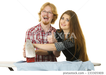 Woman teaching men how to do ironing Woman teaching men how to do ironing 133305909