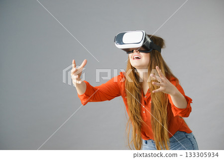 Girl wearing virtual reality goggles. Girl wearing virtual reality goggles. 133305934