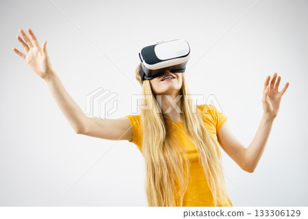 Girl wearing virtual reality goggles. 133306129
