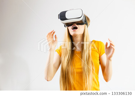 Girl wearing virtual reality goggles. 133306130