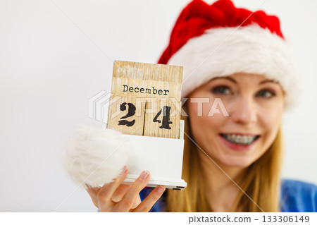Happy woman holding 24 december date 133306149