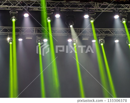 Multicolored beams of stage lighting illuminate the stage of the hall before the performance 133306378