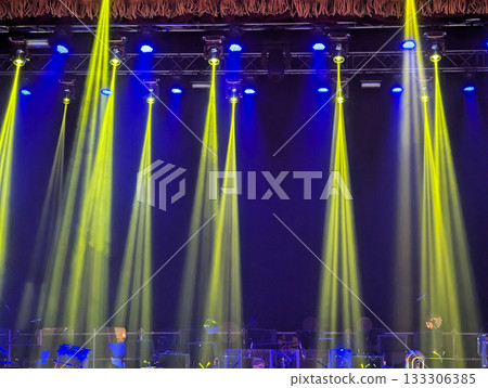 Multicolored beams of stage lighting illuminate the stage of the hall before the performance 133306385