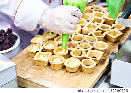 Preparing baskets with cream Preparing baskets with cream 133306758