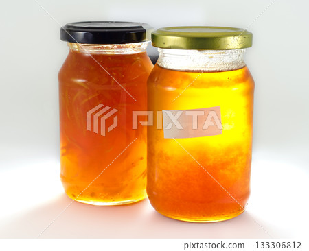 orange jam in jars with caps and labels 133306812