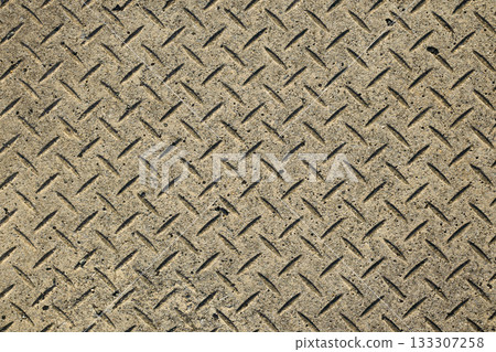 Rhombus pattern concrete texture. Close-up and surface of a gutter cover embossed with a checkerplate pattern 133307258