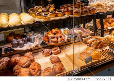 Freshly baked bread lined up in the bakery's showcase Freshly baked bread lined up in the bakery's showcase 133307441